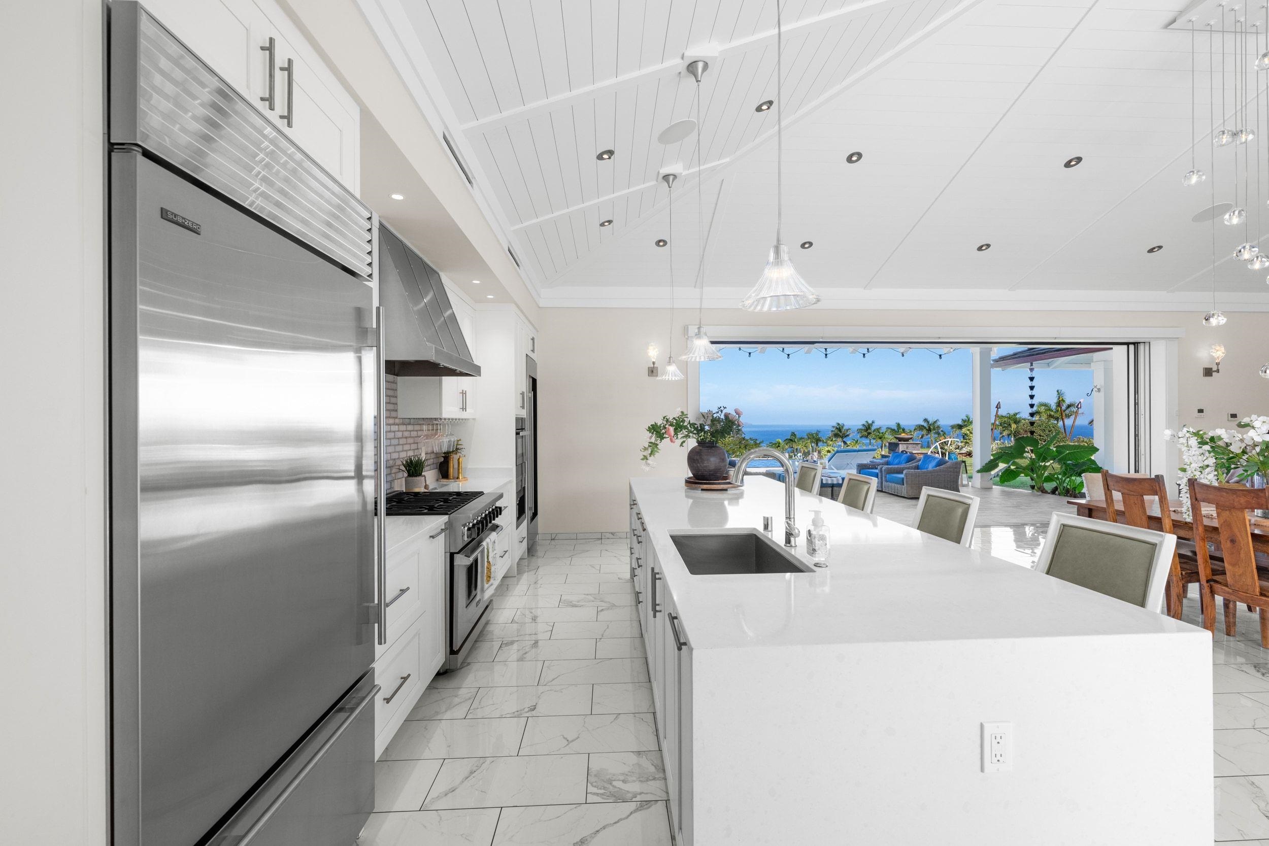 300 Mahana Ridge Street Lahaina, HI 96761 - Photo 7 of 50 a kitchen with stainless steel appliances a refrigerator a sink a stove and white cabinets