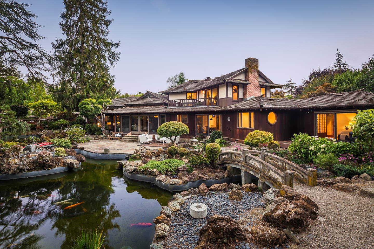 a front view of a house with swimming pool and outdoor seating