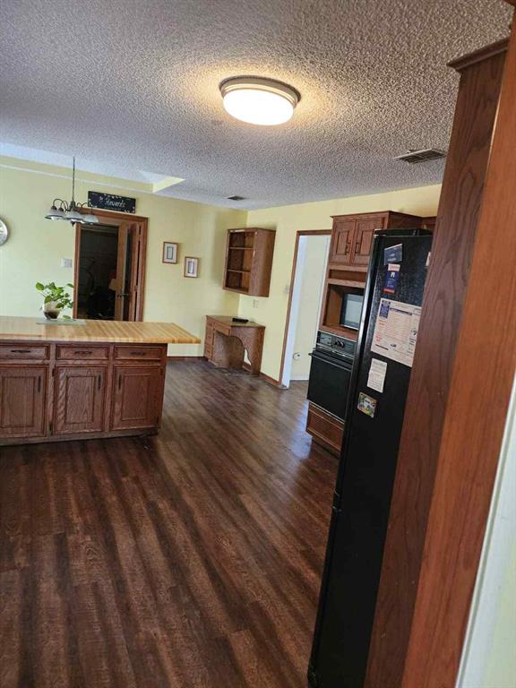 1316 Edna Street Commerce, TX 75428 - Photo 8 of 16 a living room with furniture and a flat screen tv