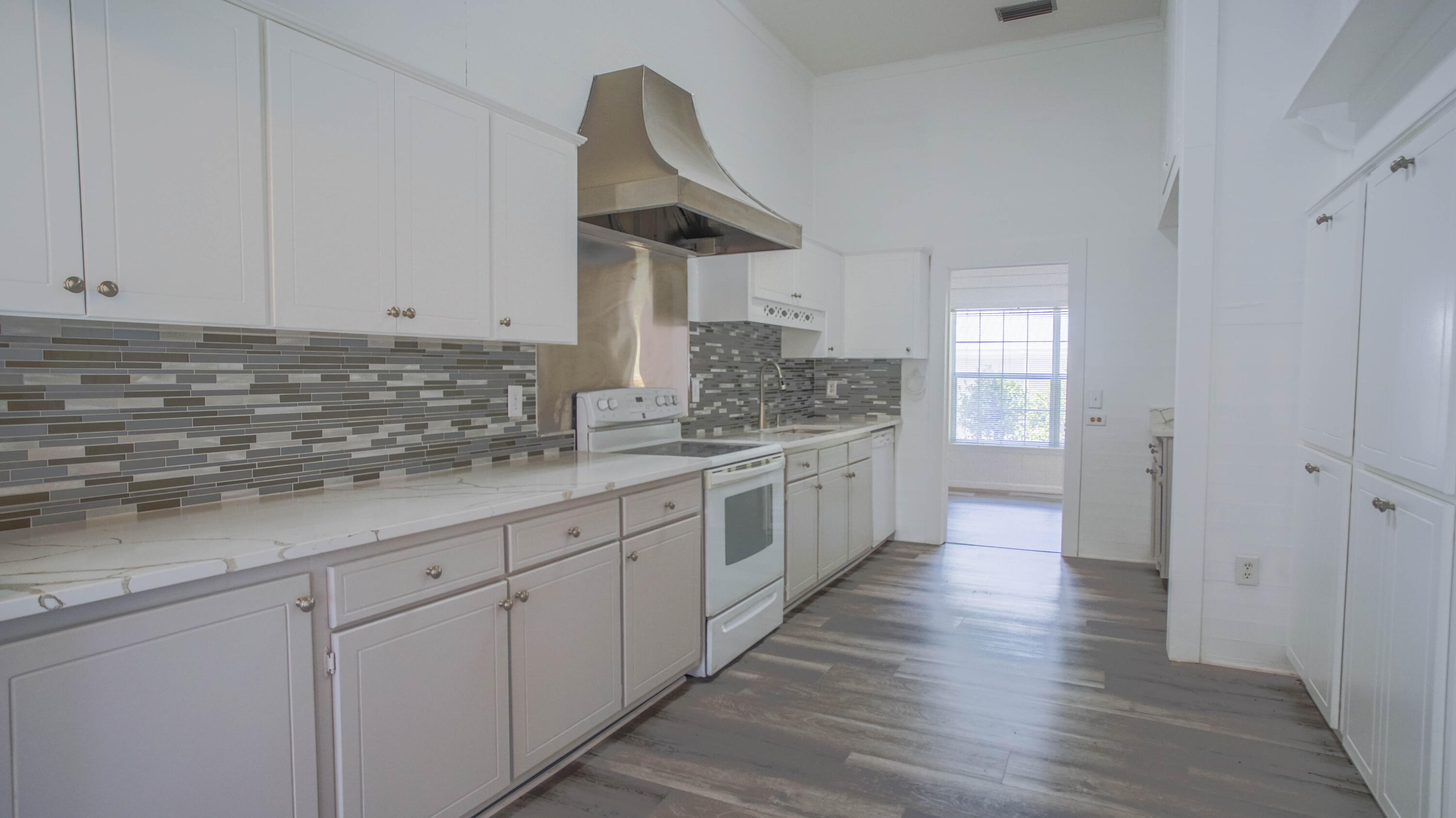 270 South 12th Street DeFuniak Springs, FL 32435 - Photo 13 of 57 a large white kitchen with white cabinets and a dishwasher