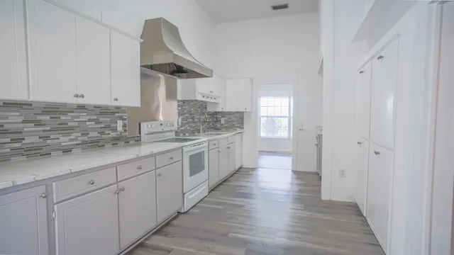 a view of a kitchen cabinets and wooden floor