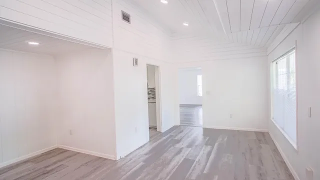 a view of a livingroom with a ceiling fan and window