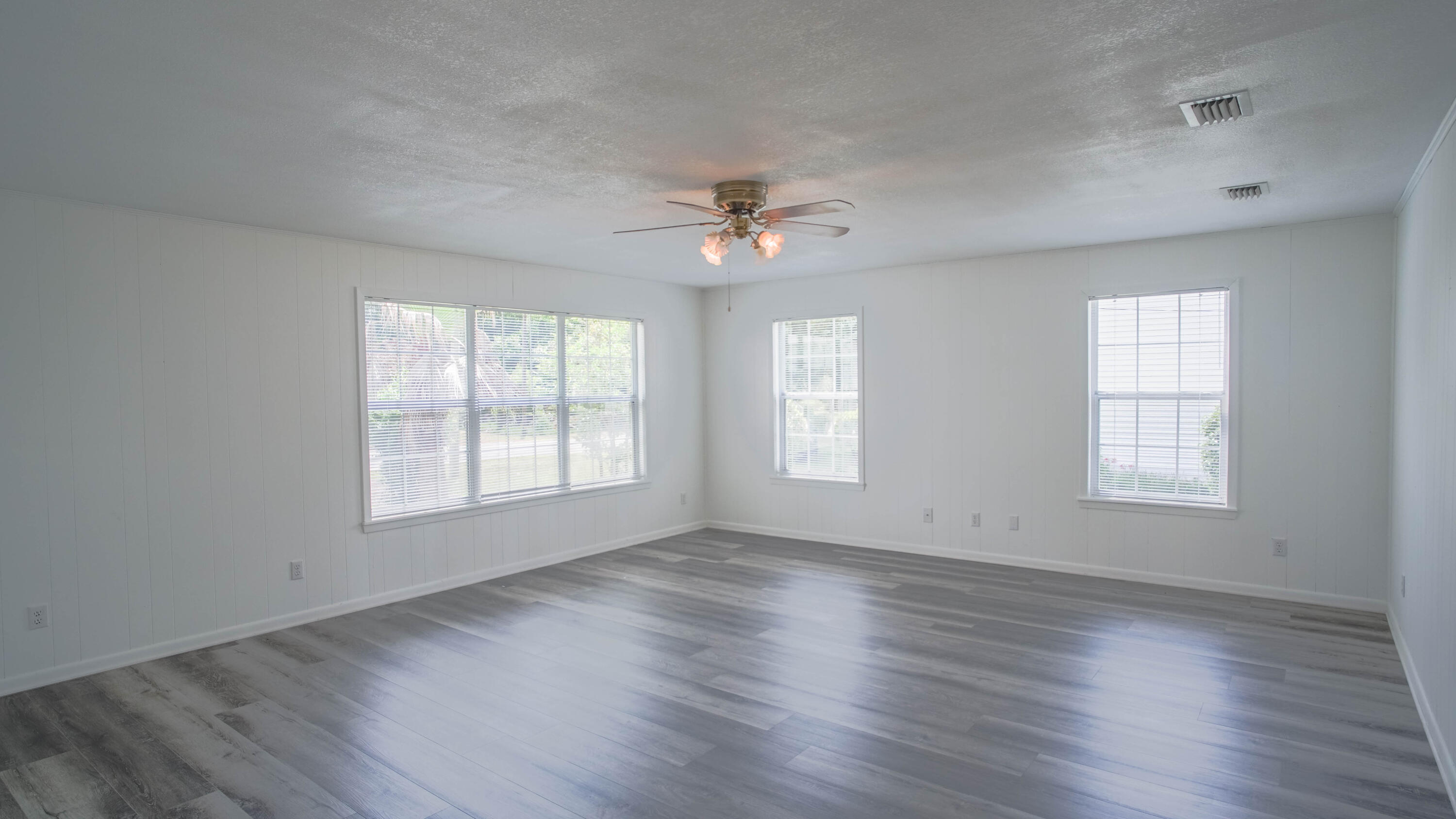 270 South 12th Street DeFuniak Springs, FL 32435 - Photo 25 of 57 a view of an empty room with wooden floor and a window