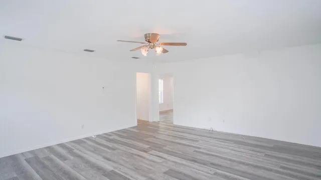 a view of a room with wooden floor