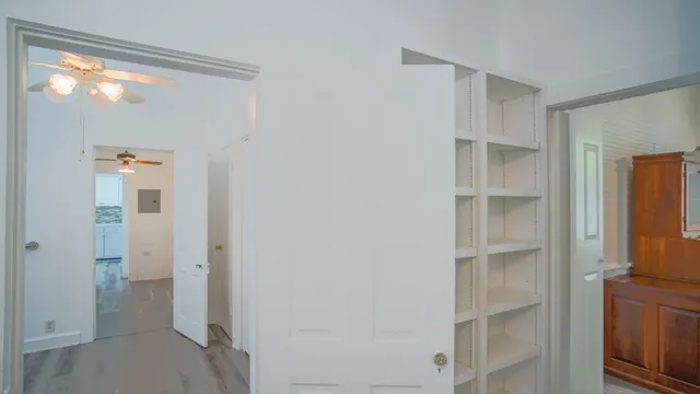 a view of a room with wooden floor