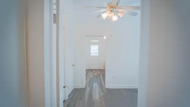 a view of walk in closet with wooden floor