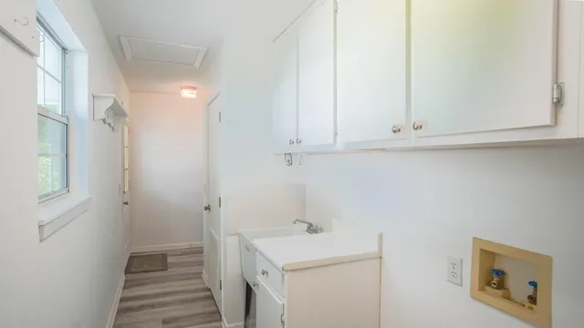 a view of a hallway with wooden floor and entryway