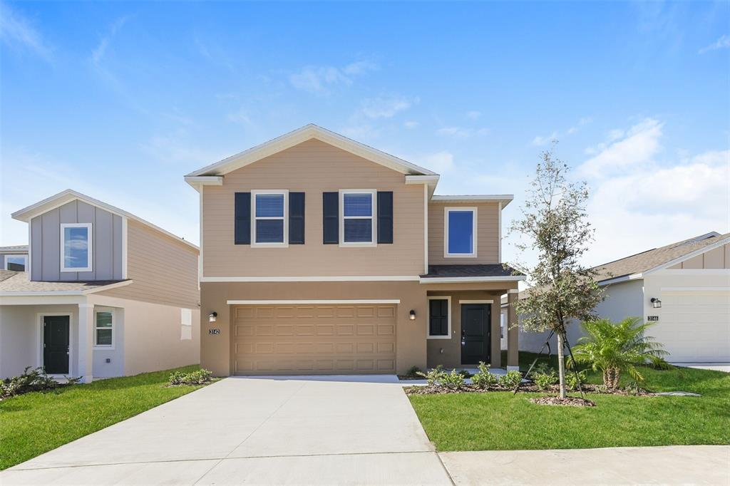3142 Totem Road Eagle Lake, FL 33839 - Photo 1 of 1 a front view of a house with garden