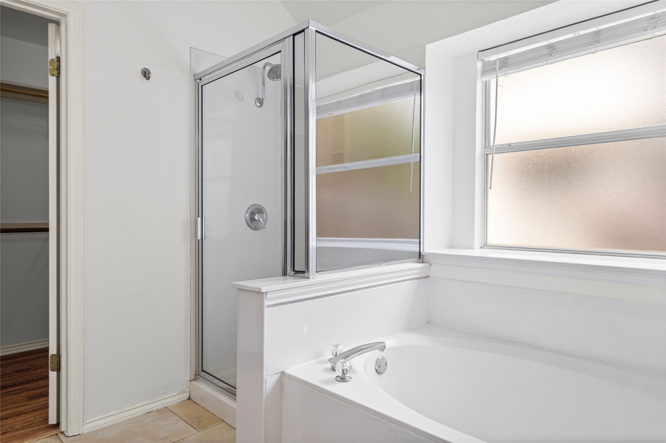 2920 Warwick Way Austin, TX 78748 - Photo 21 of 36 Spacious and bright primary bathroom with walk-in closet, dual vanities, garden tub, and separate shower