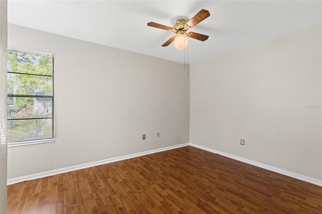 4345 Southwest 20th Lane Gainesville, FL 32607 - Photo 11 of 17 an empty room with wooden floor and window