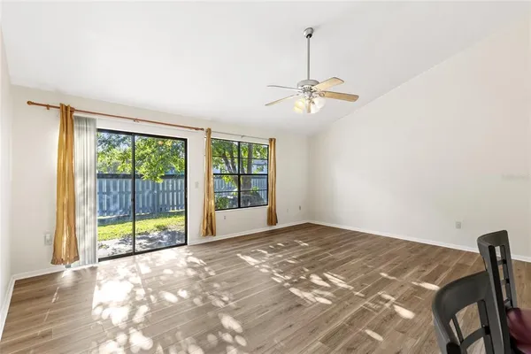 a view of a livingroom with a ceiling fan and window