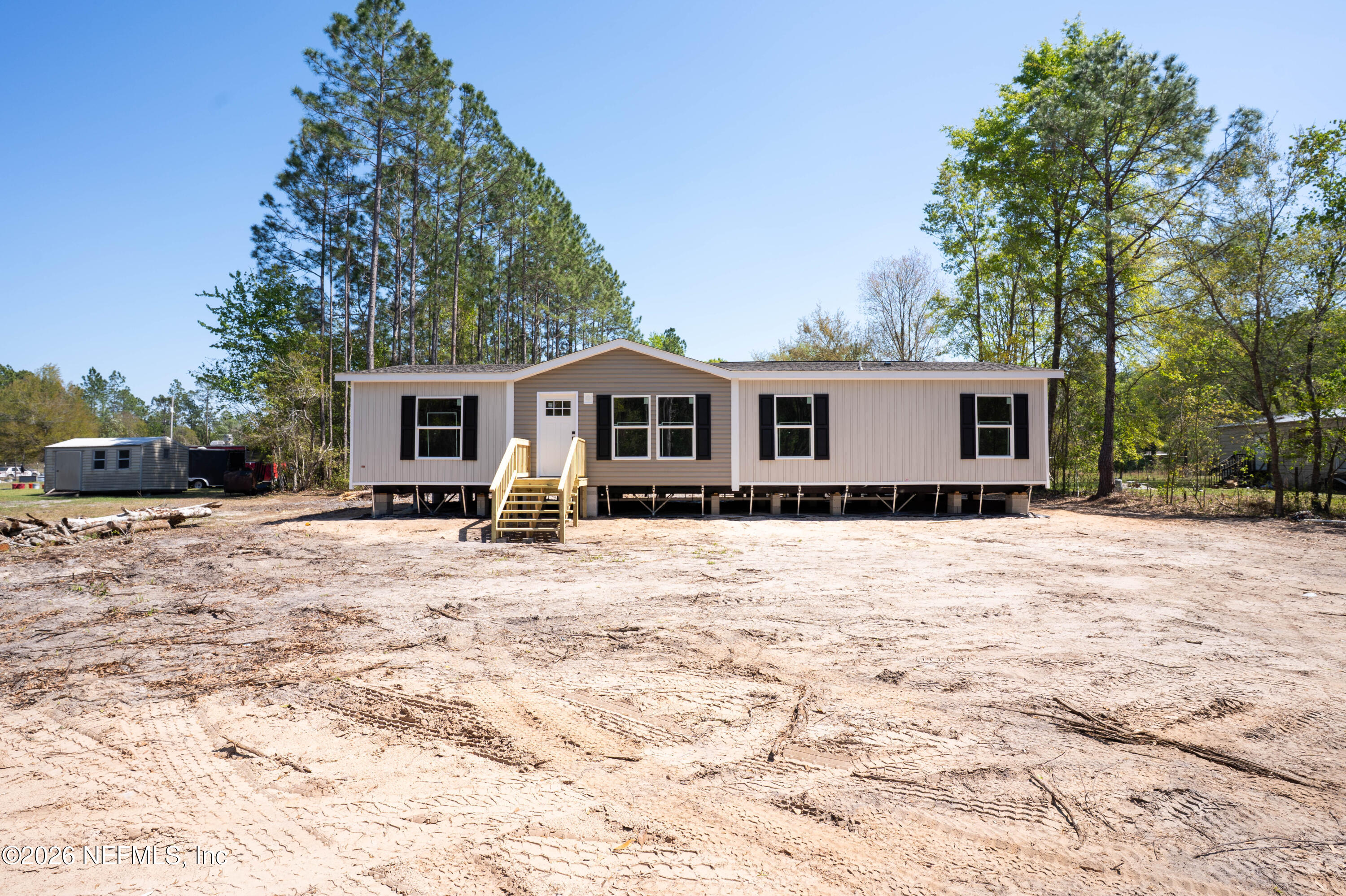 10101 Co Road Sanderson, FL 32087 - Photo 2 of 10 a view of a house with snow on the road