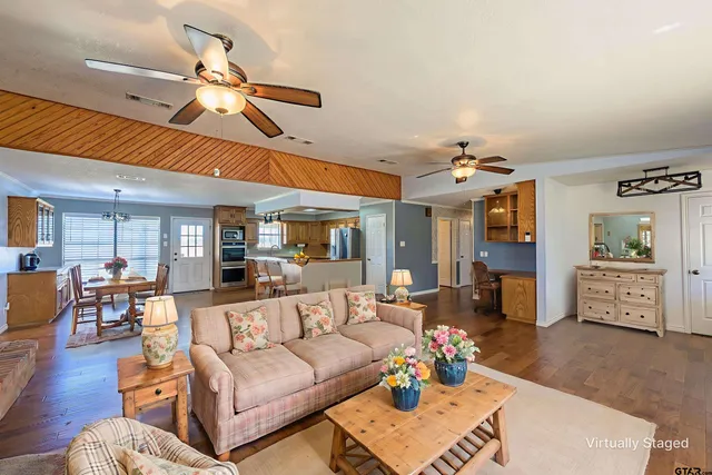 a view of a livingroom with furniture and a ceiling fan