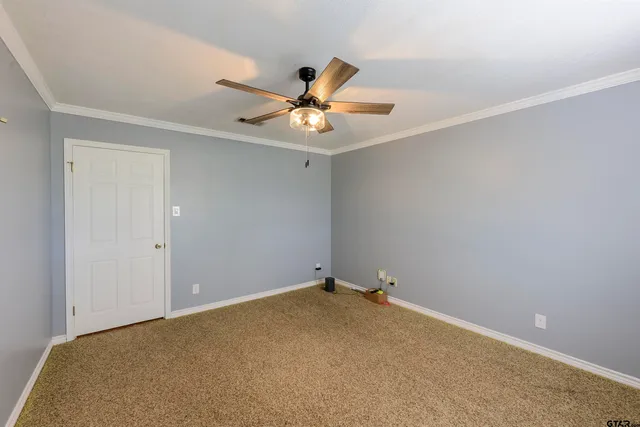 a view of a room with a ceiling fan and a window