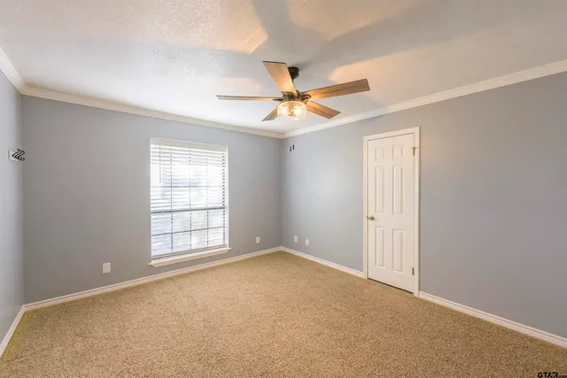 a view of a livingroom with a ceiling fan and window