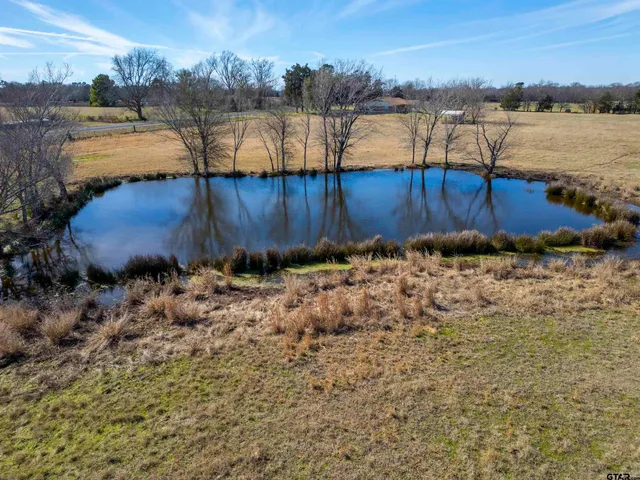 a aerial view of a house with a yard and sitting area