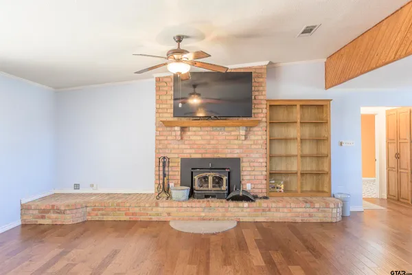 a living room with furniture a fireplace and a flat screen tv