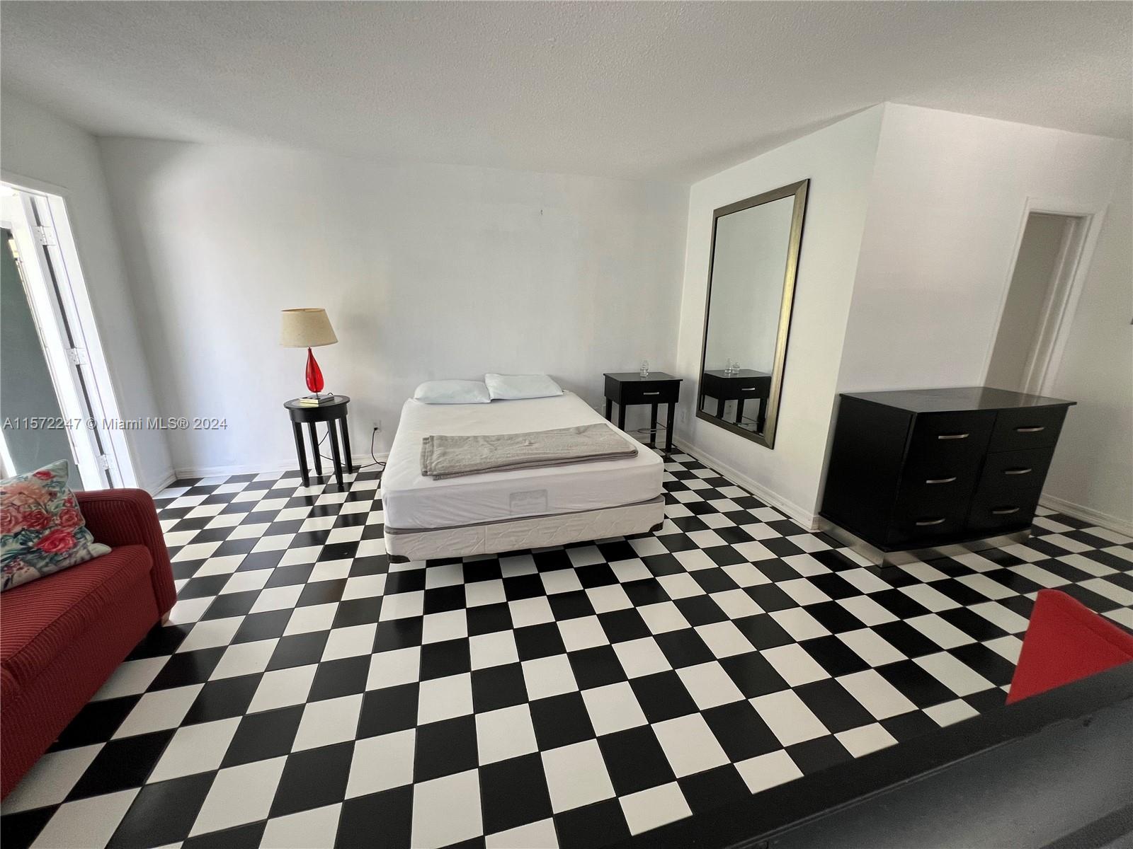 a living room with a black white checkered floor with a black white checkered floor