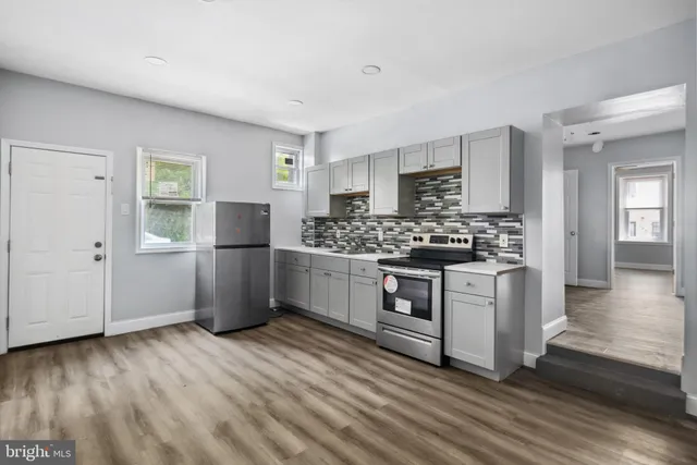 a kitchen with stainless steel appliances a refrigerator stove and sink