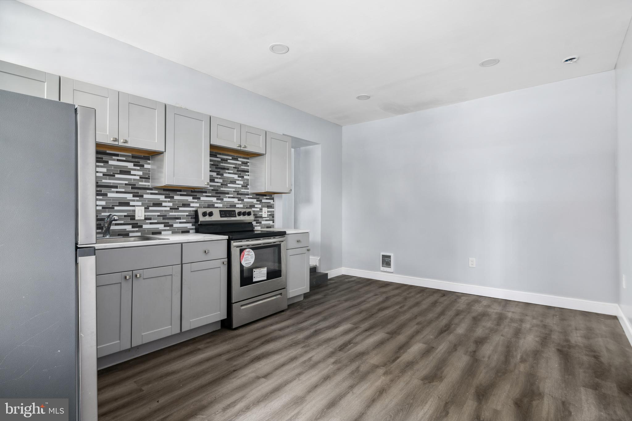171 East Sharpnack Street Philadelphia, PA 19119 - Photo 2 of 15 a kitchen with stainless steel appliances a stove a sink and white cabinets