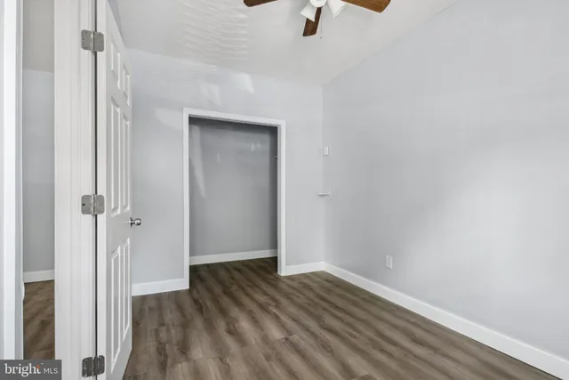 a view of a room with wooden floor closet and windows