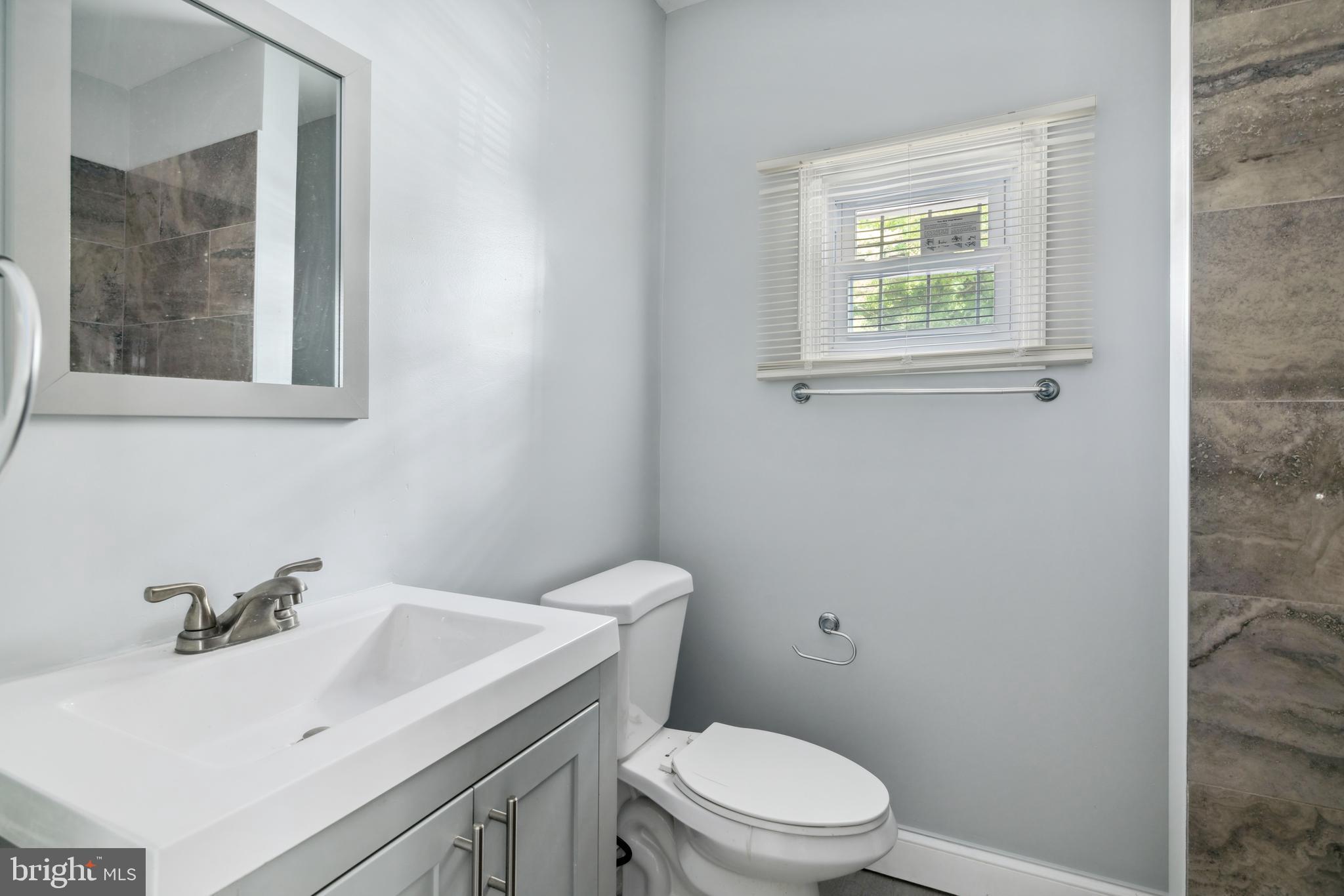 171 East Sharpnack Street Philadelphia, PA 19119 - Photo 7 of 15 a bathroom with a sink a toilet and mirror