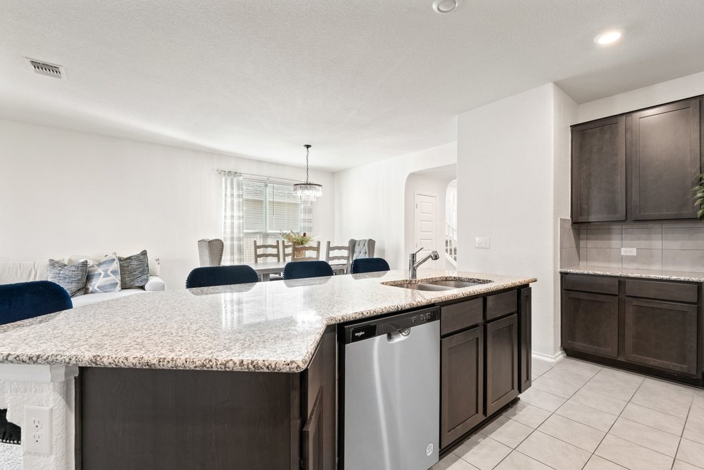 218 Summit Drive Lockhart, TX 78644 - Photo 11 of 38 a kitchen with granite countertop a sink and cabinets