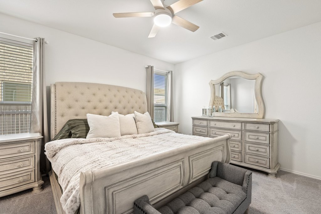 218 Summit Drive Lockhart, TX 78644 - Photo 20 of 38 a bedroom with a bed and a chandelier