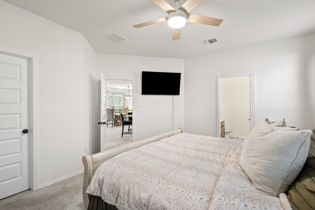218 Summit Drive Lockhart, TX 78644 - Photo 22 of 38 a bedroom with a bed and a flat screen tv