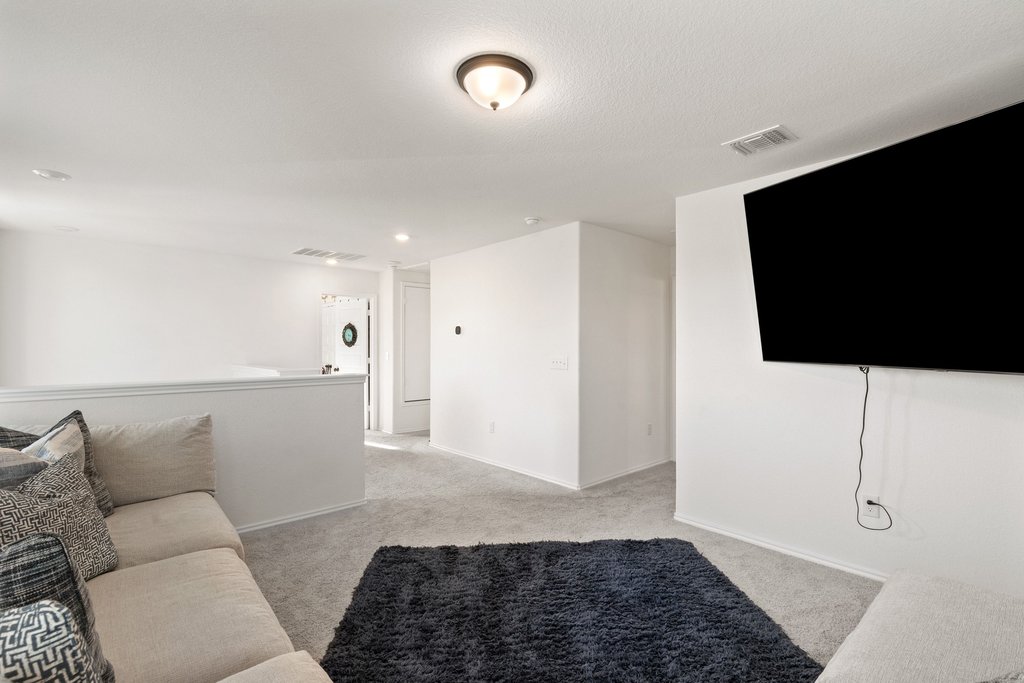 218 Summit Drive Lockhart, TX 78644 - Photo 26 of 38 a living room with furniture and a flat screen tv