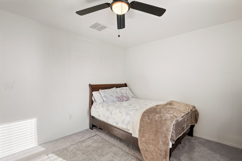 218 Summit Drive Lockhart, TX 78644 - Photo 27 of 38 a bedroom with a bed and chandelier