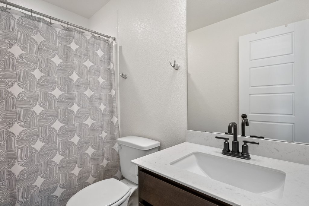 218 Summit Drive Lockhart, TX 78644 - Photo 31 of 38 a bathroom with a sink a toilet and shower