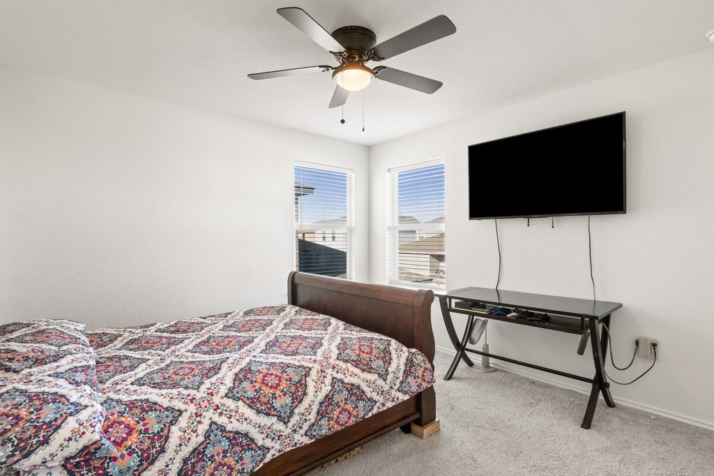 218 Summit Drive Lockhart, TX 78644 - Photo 32 of 38 a bedroom with a bed and a flat screen tv