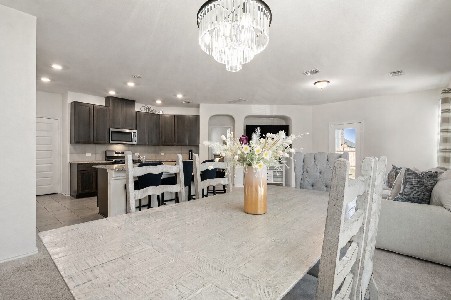 218 Summit Drive Lockhart, TX 78644 - Photo 7 of 38 a kitchen with stainless steel appliances kitchen island granite countertop a refrigerator and stove