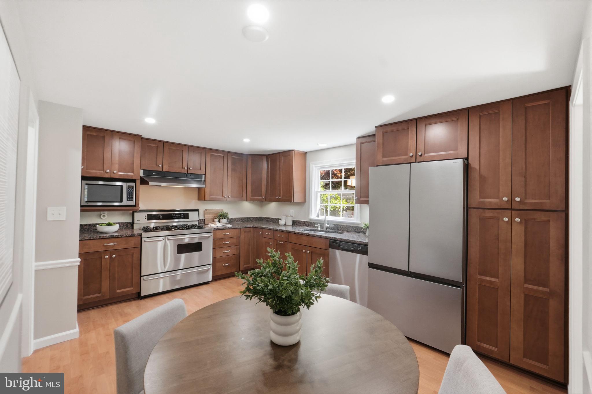 8008 Inspection House Road Potomac, MD 20854 - Photo 6 of 43 Modern kitchen with warm wood tones.