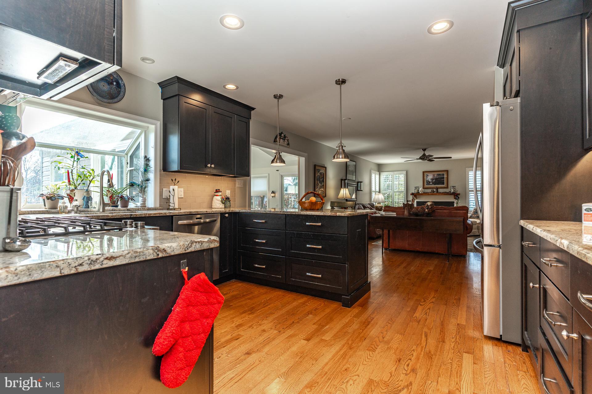 820 Waverly Road Kennett Square, PA 19348 - Photo 12 of 46 a kitchen with stainless steel appliances kitchen island granite countertop a refrigerator and a stove top oven