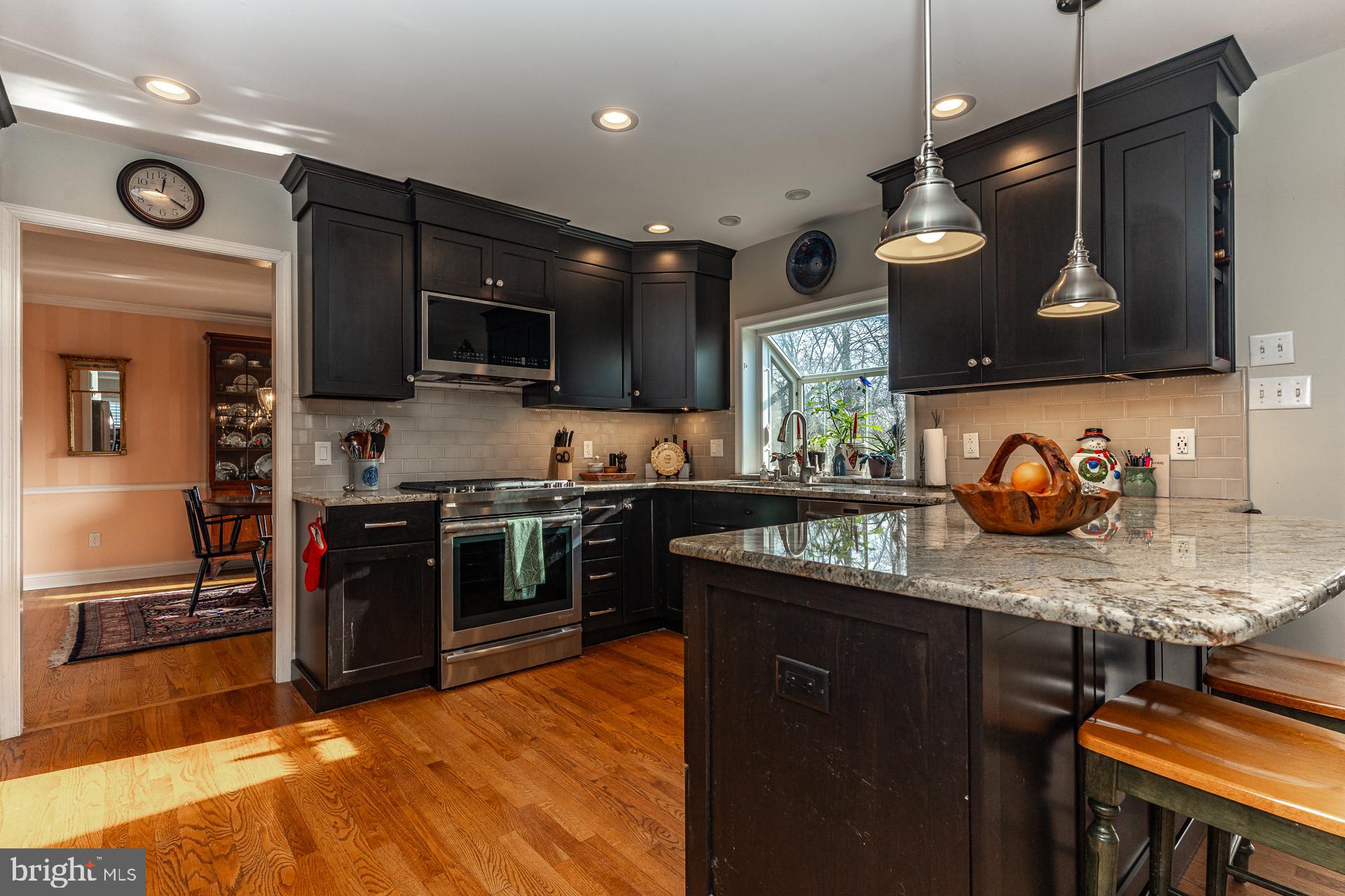820 Waverly Road Kennett Square, PA 19348 - Photo 13 of 46 a kitchen with stainless steel appliances granite countertop a stove a sink and a microwave