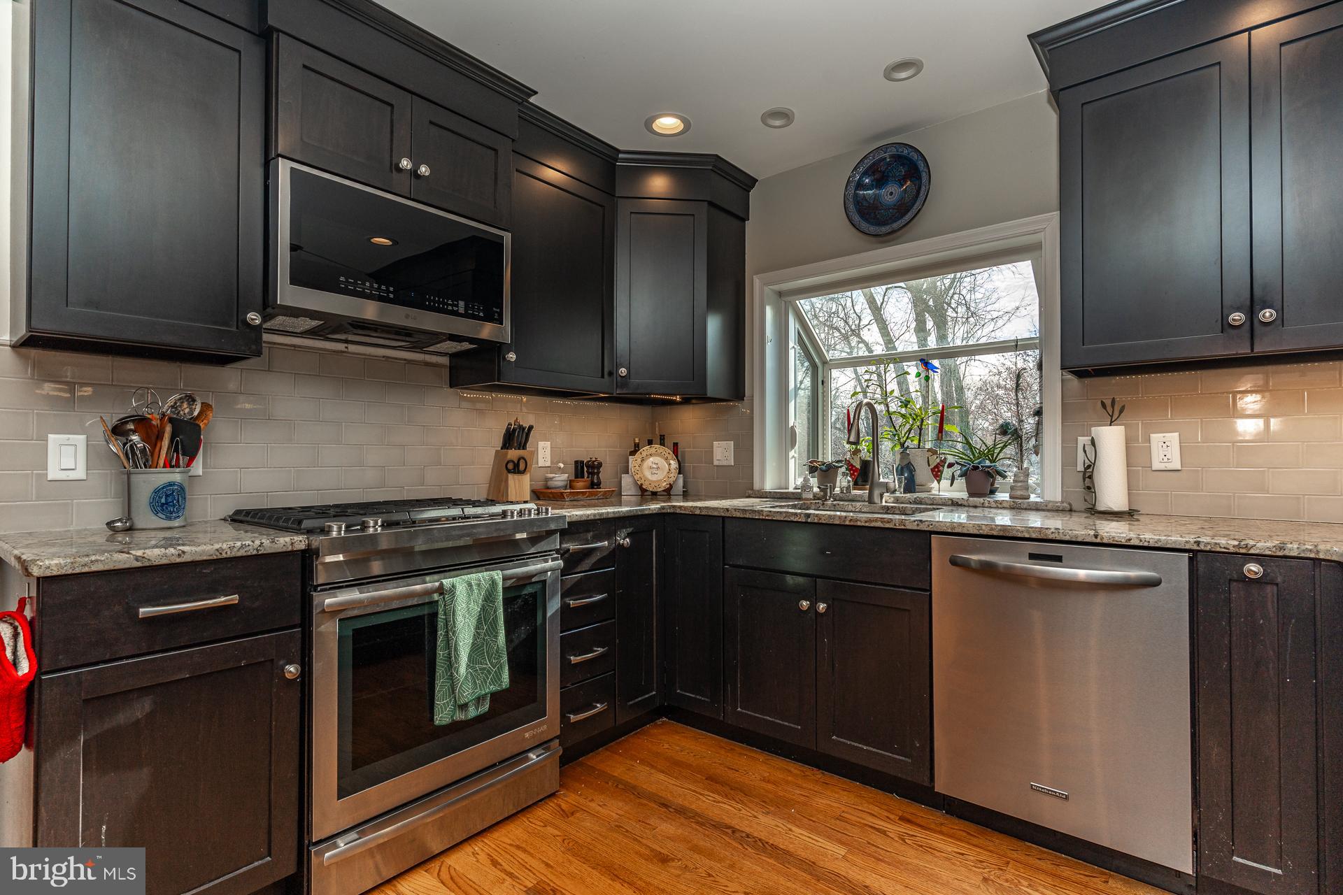 820 Waverly Road Kennett Square, PA 19348 - Photo 14 of 46 a kitchen with stainless steel appliances wooden cabinets and a stove top oven