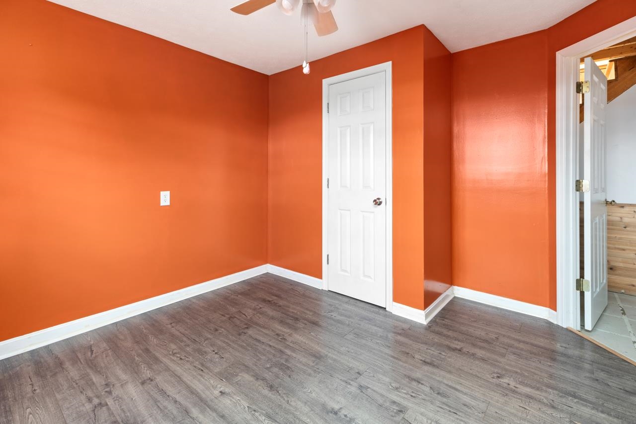 1052 Dutch Hollow Road Raphine, VA 24472 - Photo 26 of 46 a view of an empty room with wooden floor and a window