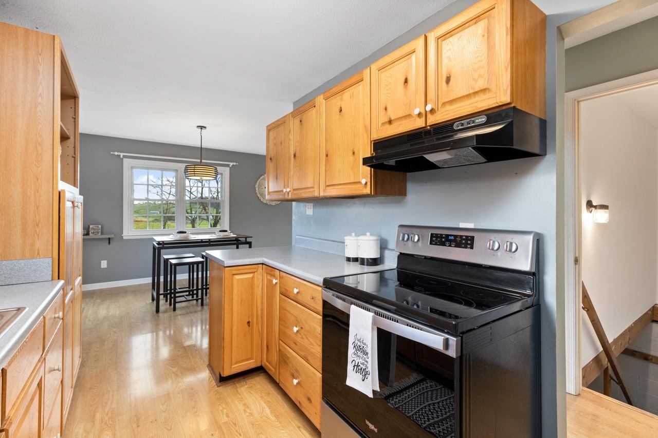 1052 Dutch Hollow Road Raphine, VA 24472 - Photo 5 of 46 a kitchen with stainless steel appliances granite countertop a stove a sink and a refrigerator
