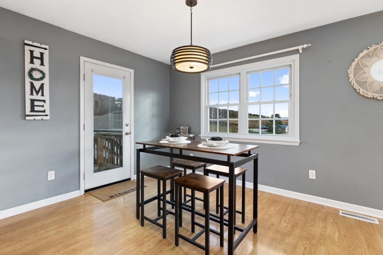 1052 Dutch Hollow Road Raphine, VA 24472 - Photo 6 of 46 a view of a dining room with furniture window and wooden floor