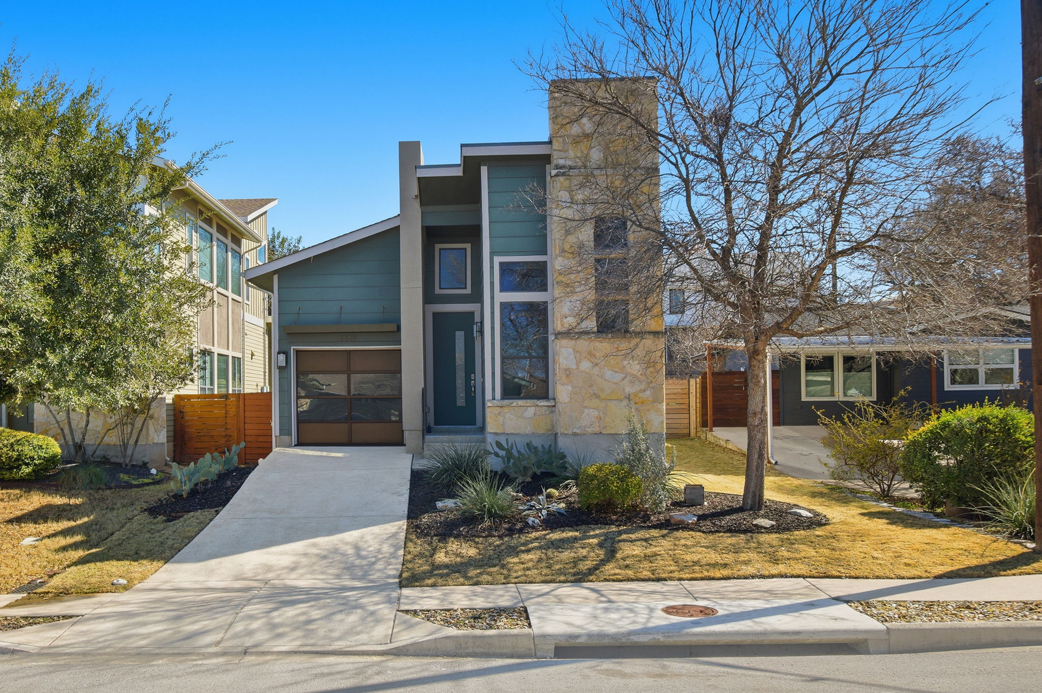 a front view of a house with garden and plants