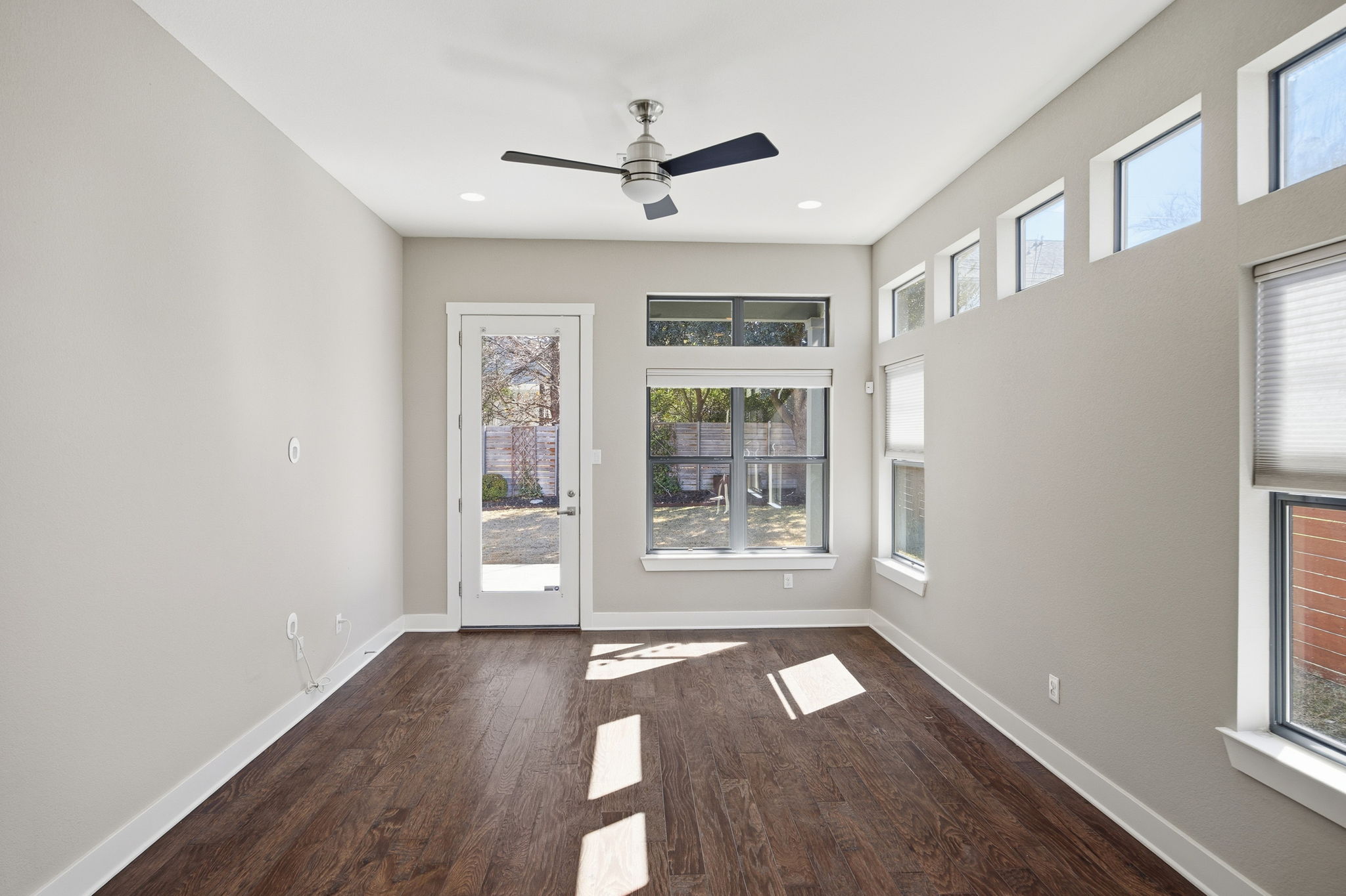 3521 Marcae Court Austin, TX 78704 - Photo 16 of 37 Empty room featuring dark wood-style flooring, a ceiling fan, and recessed lighting