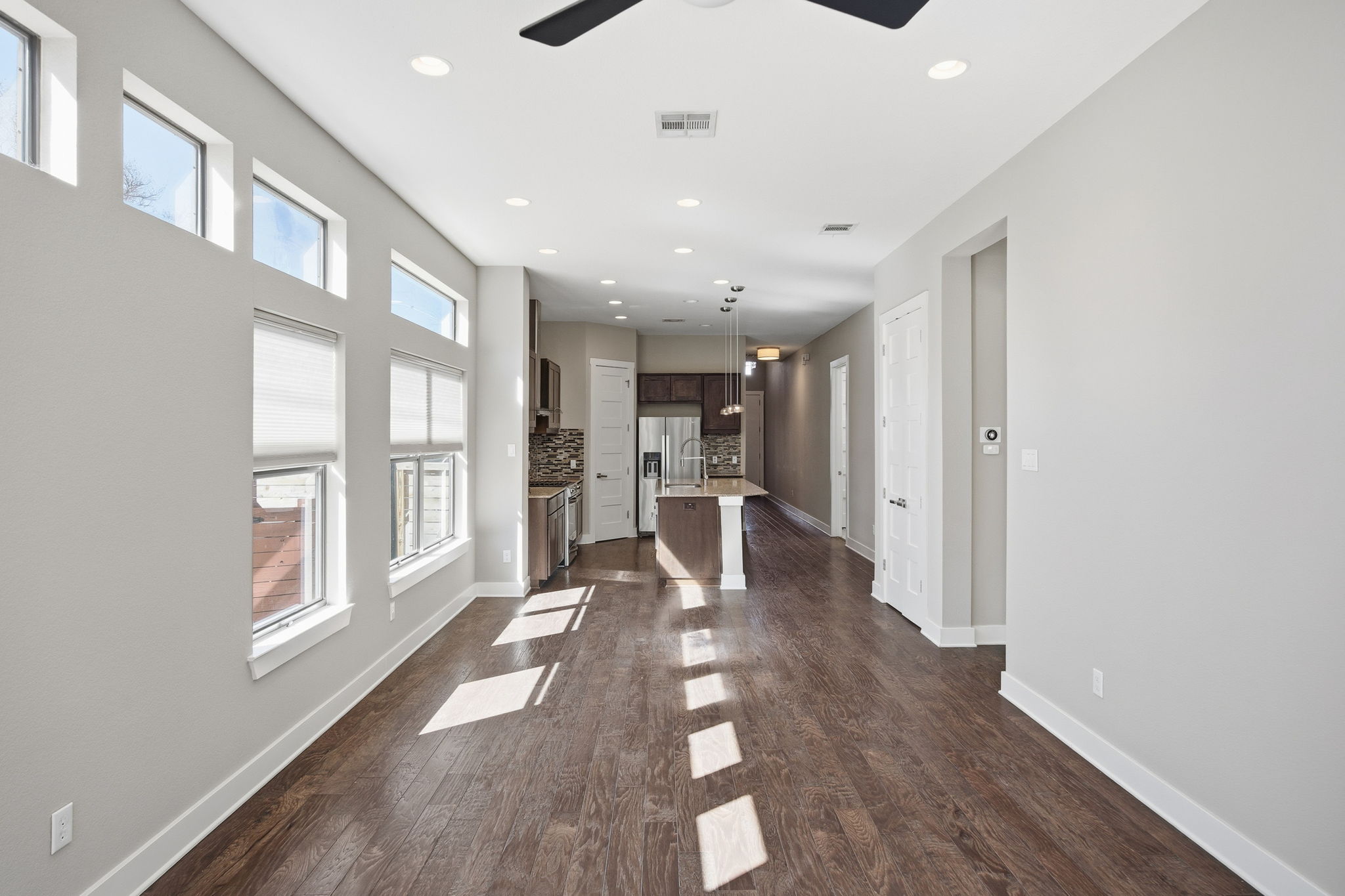 3521 Marcae Court Austin, TX 78704 - Photo 17 of 37 Unfurnished living room with dark wood-type flooring, recessed lighting, and ceiling fan
