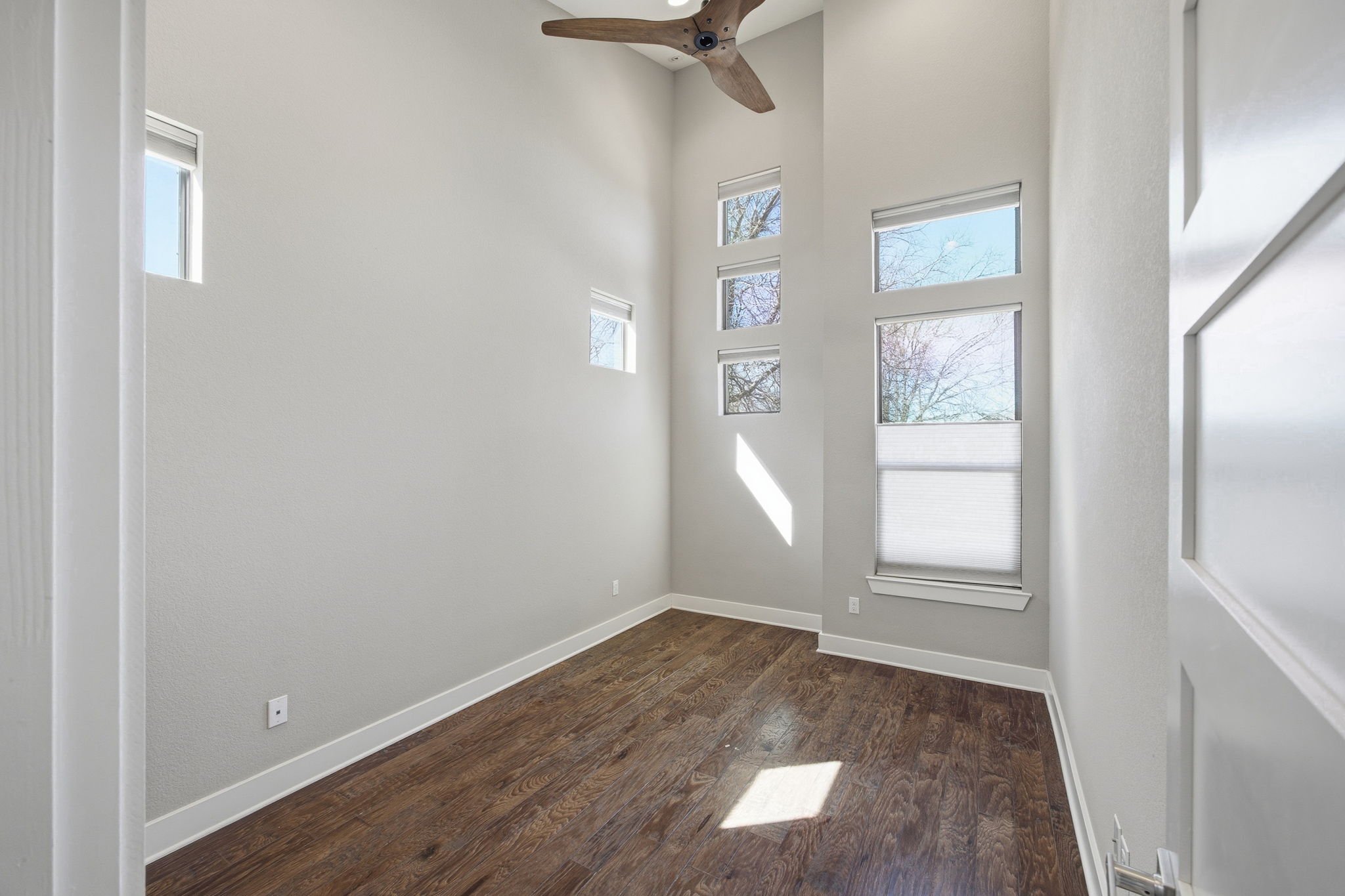 3521 Marcae Court Austin, TX 78704 - Photo 21 of 37 Spare room with dark wood-type flooring, a high ceiling, and ceiling fan