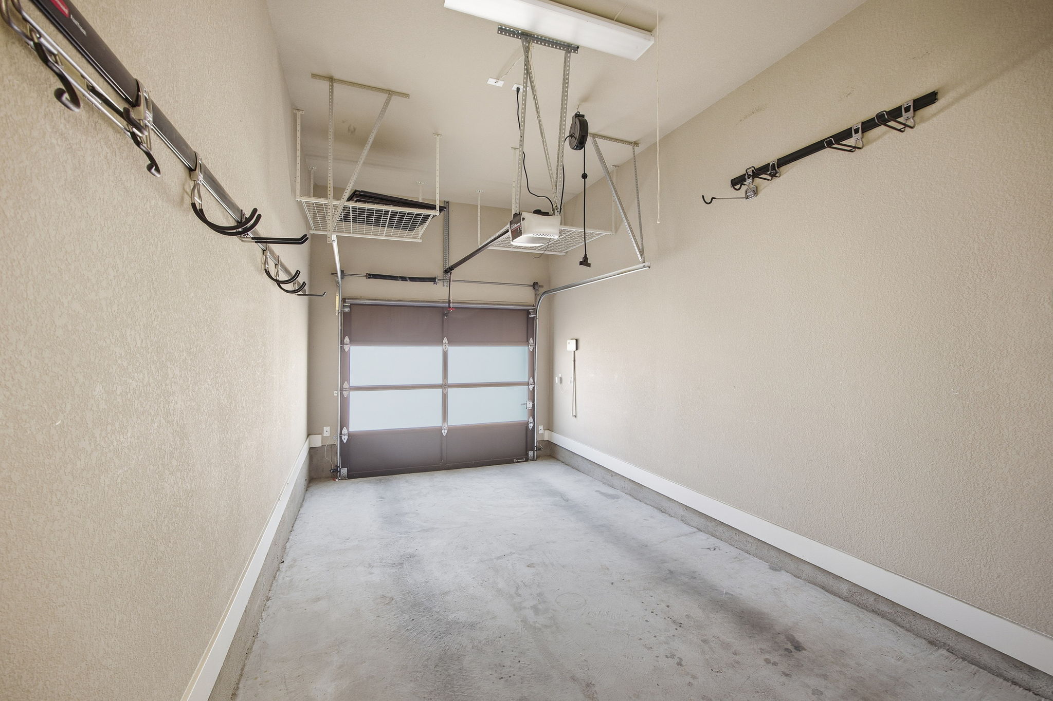 3521 Marcae Court Austin, TX 78704 - Photo 33 of 37 Garage featuring a textured wall and a garage door opener
