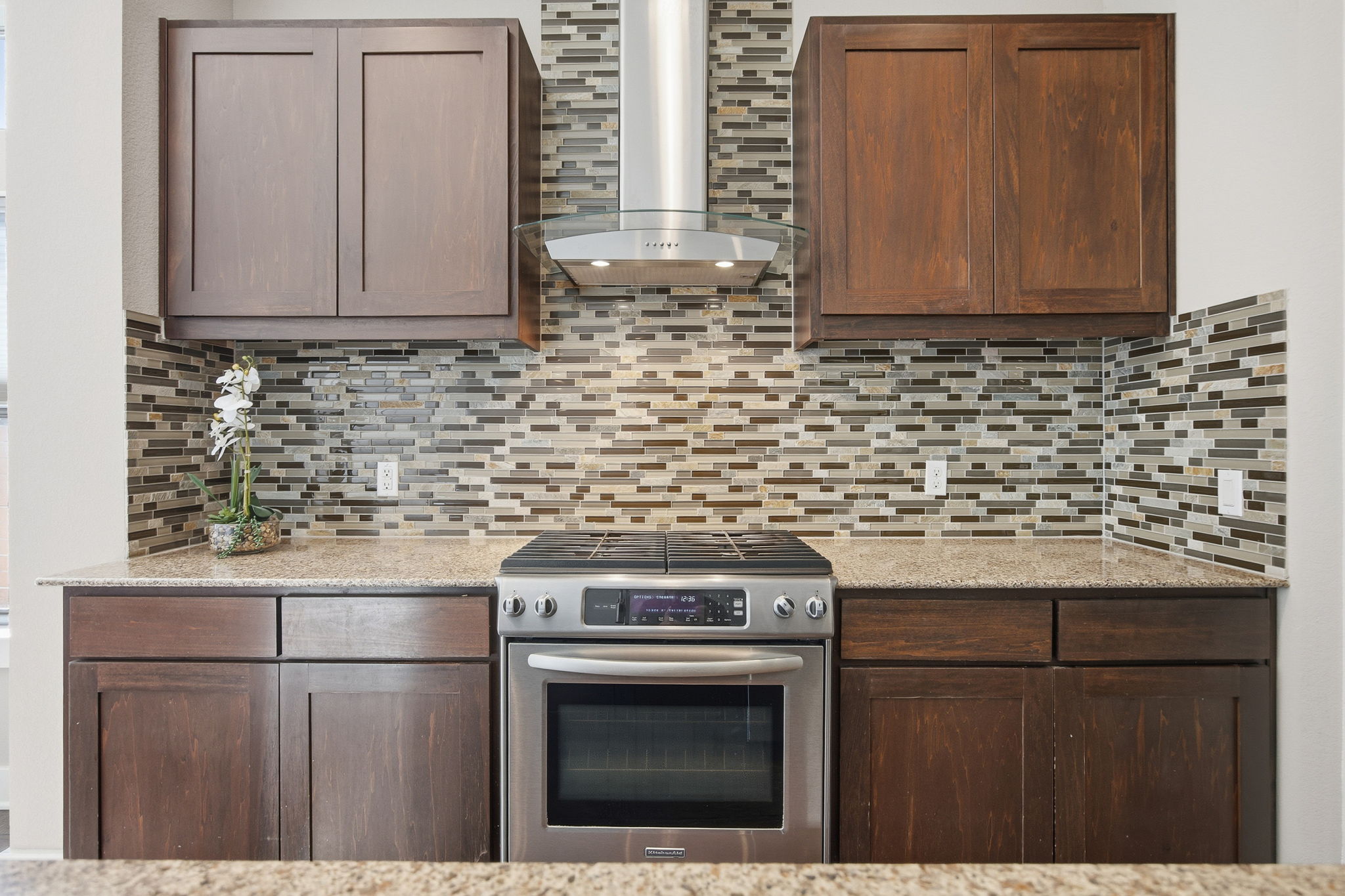 3521 Marcae Court Austin, TX 78704 - Photo 5 of 37 Kitchen with stainless steel range with gas stovetop, light stone counters, and tasteful backsplash