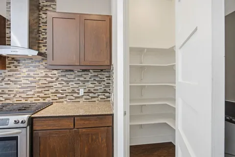 a kitchen with stainless steel appliances granite countertop a refrigerator and a stove