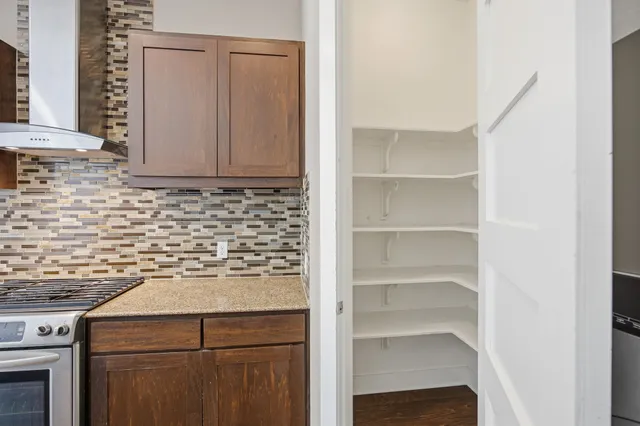 a kitchen with stainless steel appliances granite countertop a refrigerator and a stove