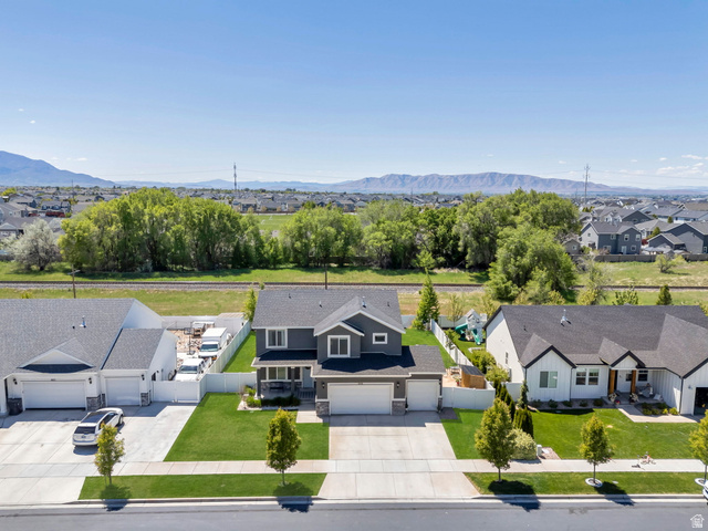 646 South Meade Street Mapleton, UT 84664 - Photo 27 of 46 Two-story residence featuring a dark gray exterior with white trim, a covered front porch, and an attached two-car garage